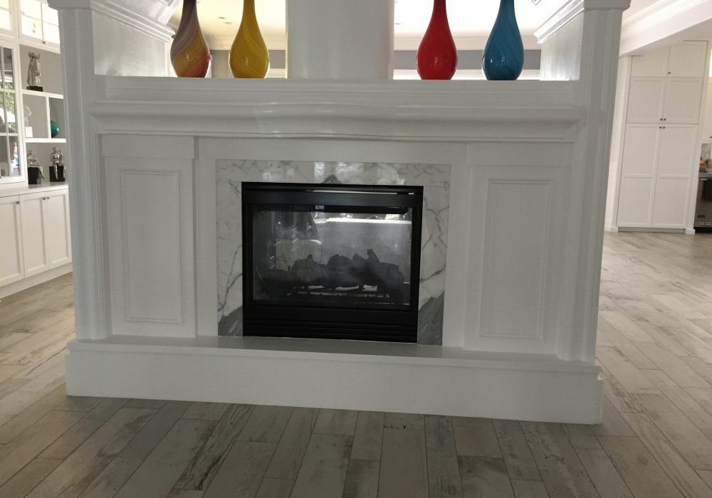 There is a fireplace in the middle of the room.
