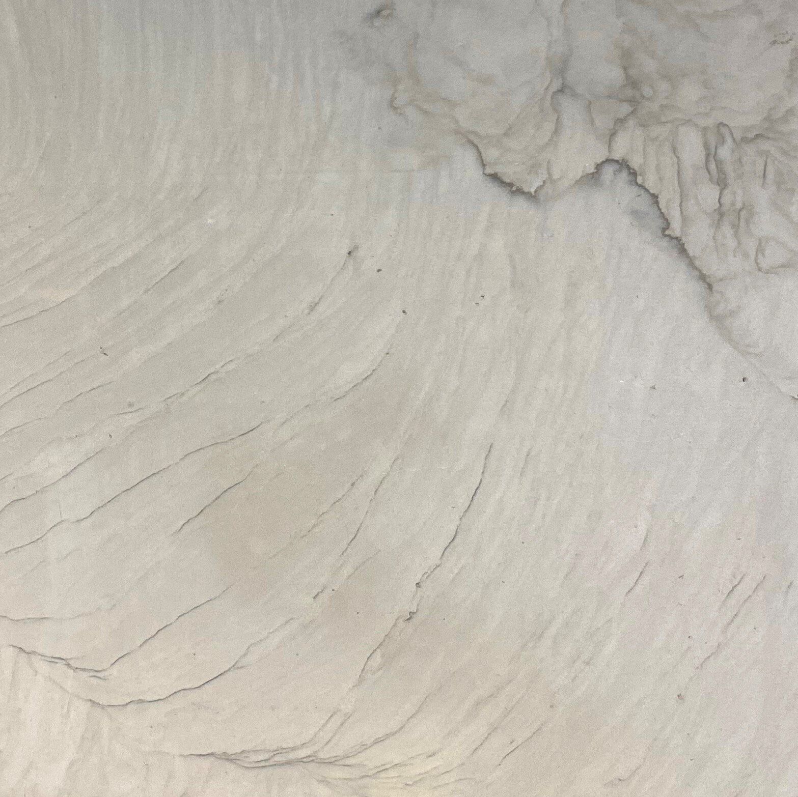 A close up of a white marble counter top.