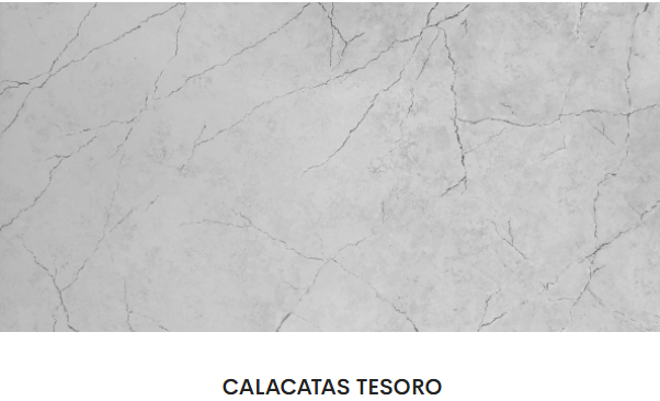 A close up of a white marble slab with the words calacatas tesoro below it.
