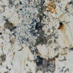 A close up of a white granite counter top.