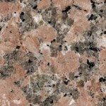A close up of a pink granite counter top.