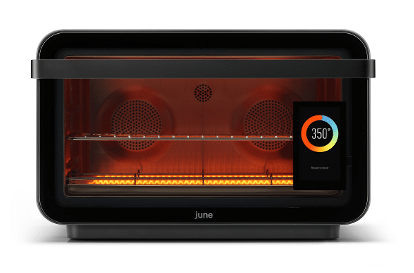 A black toaster oven with a thermometer on the front of it.