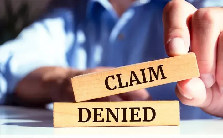 A person holds a wooden block labeled 