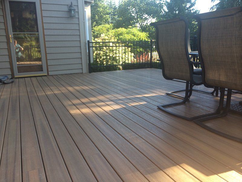 Wooden deck with outdoor furniture and a door.