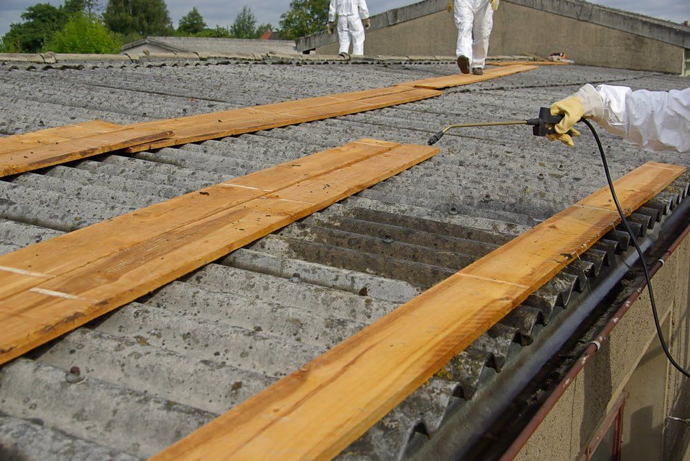 Spraying Chemical on Asbestos Roof — Asbestos Removal in Currajong, QLD