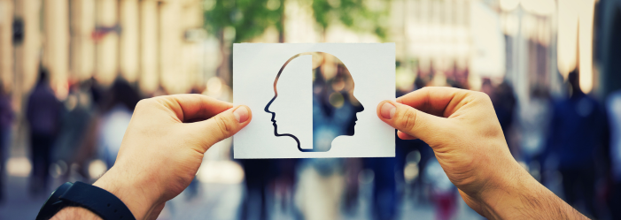 emotional intelligence concept: hands holding the silhouette on paper of a face