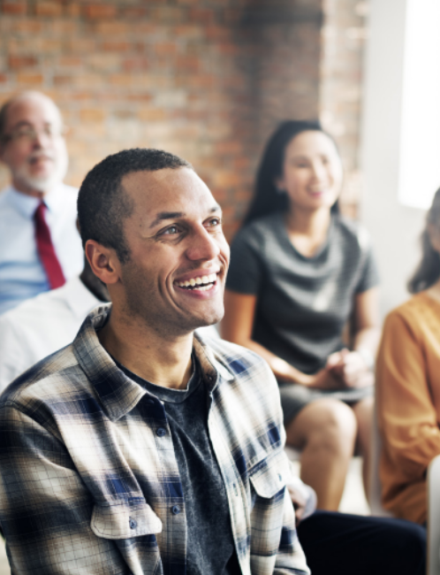 team members smile at a leader