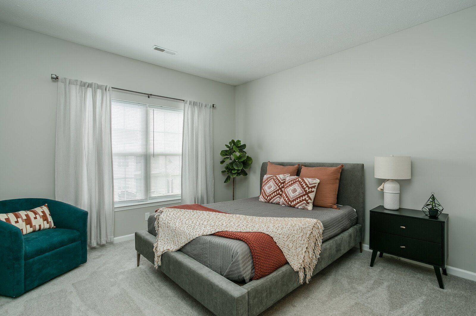 Carpeted bedroom with large window