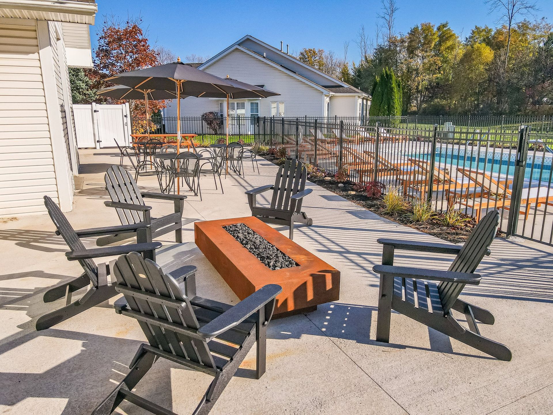 Outdoor Patio with Firepit and Adirondack Chairs