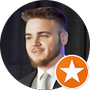 A man in a suit and tie is standing in a circle with an orange star.