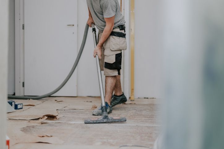 Post-construction cleaning service in Chicago being displayed my a man cleaning up post construction.