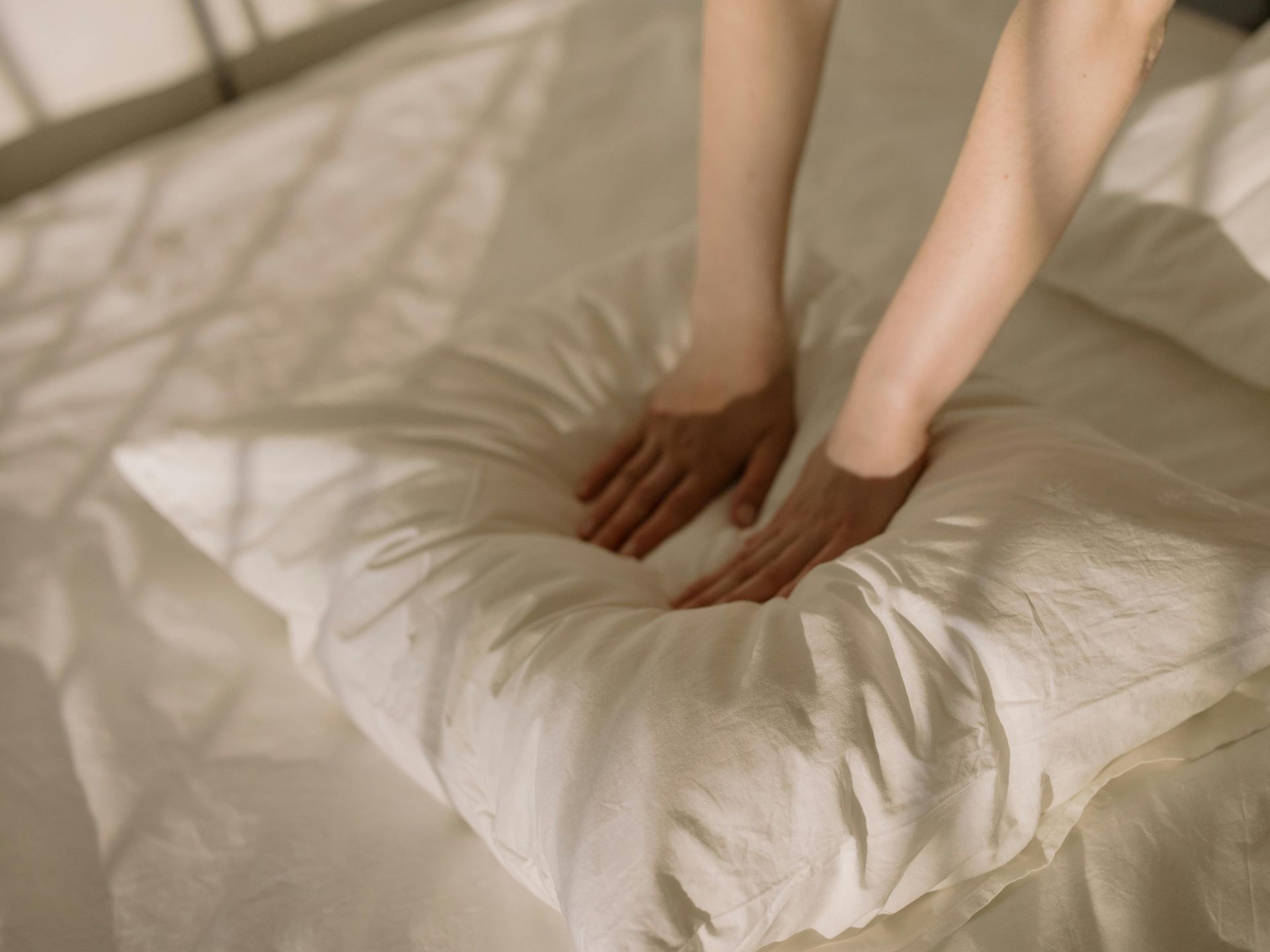 A cleaner making the bed.