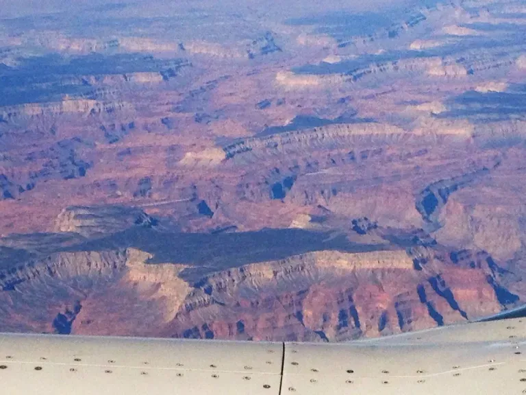 An aerial view of the grand canyon from an airplane window