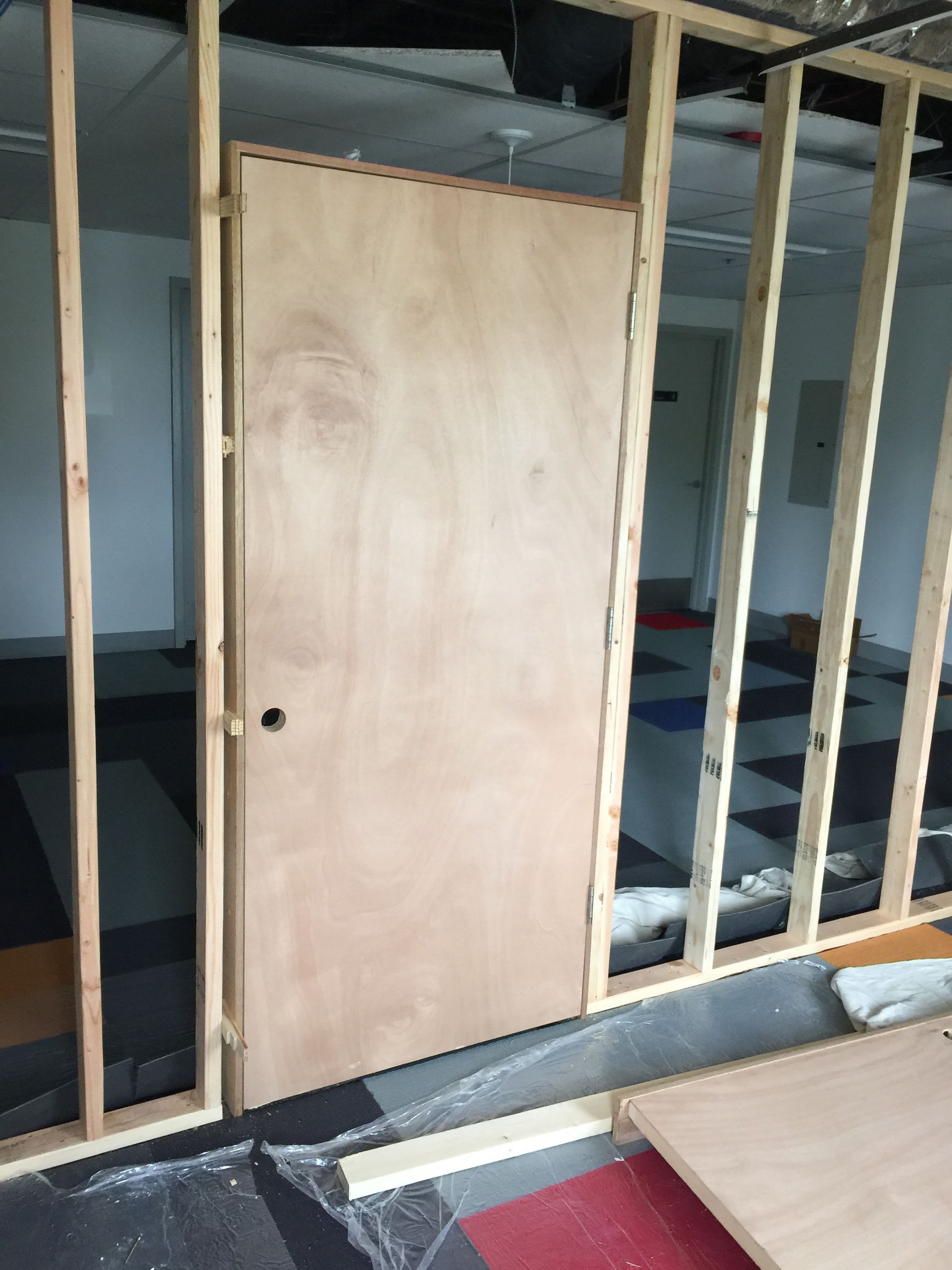 A wooden door is being built into a wall.