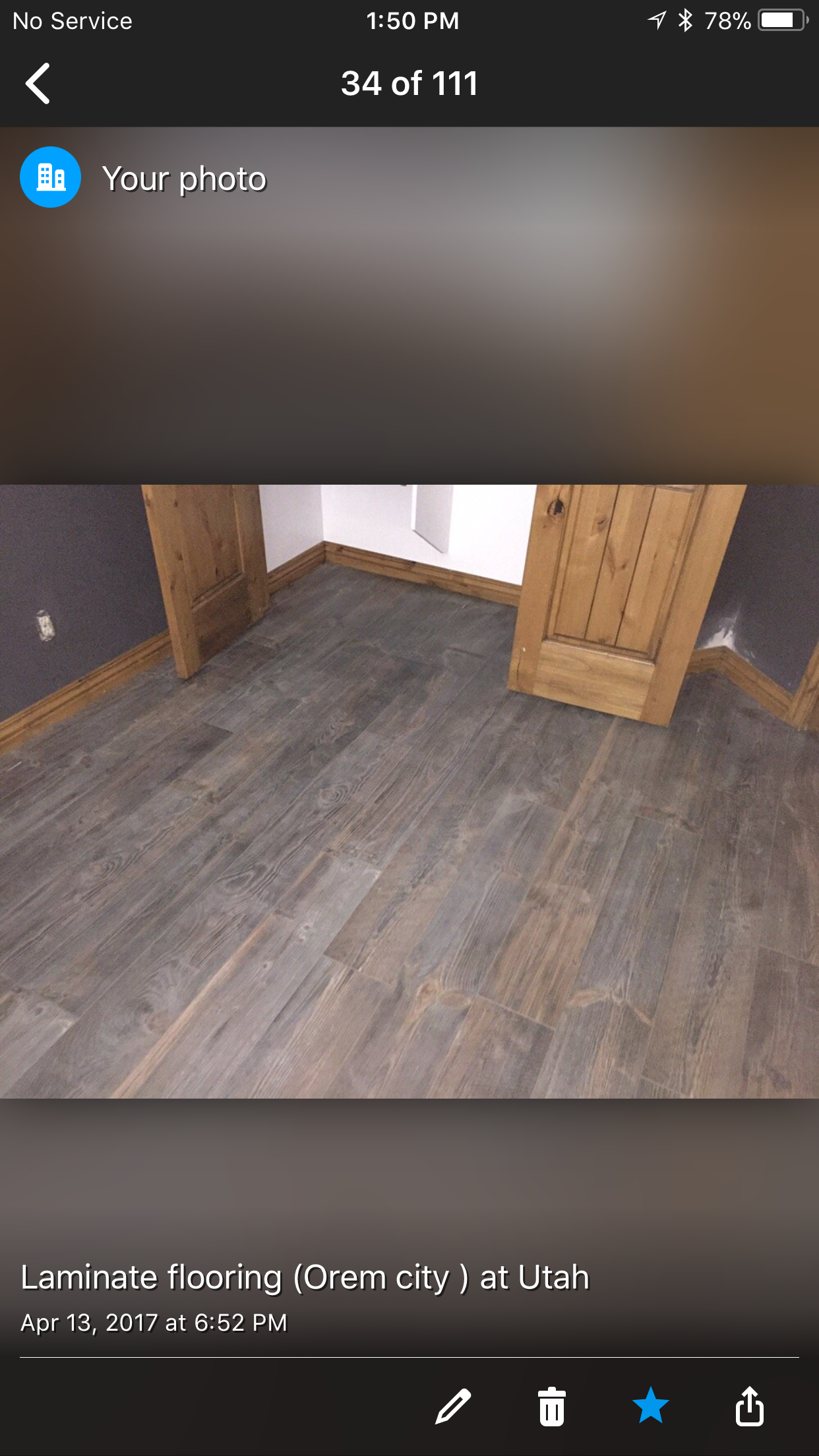 A picture of a wooden floor in a room on a cell phone.
