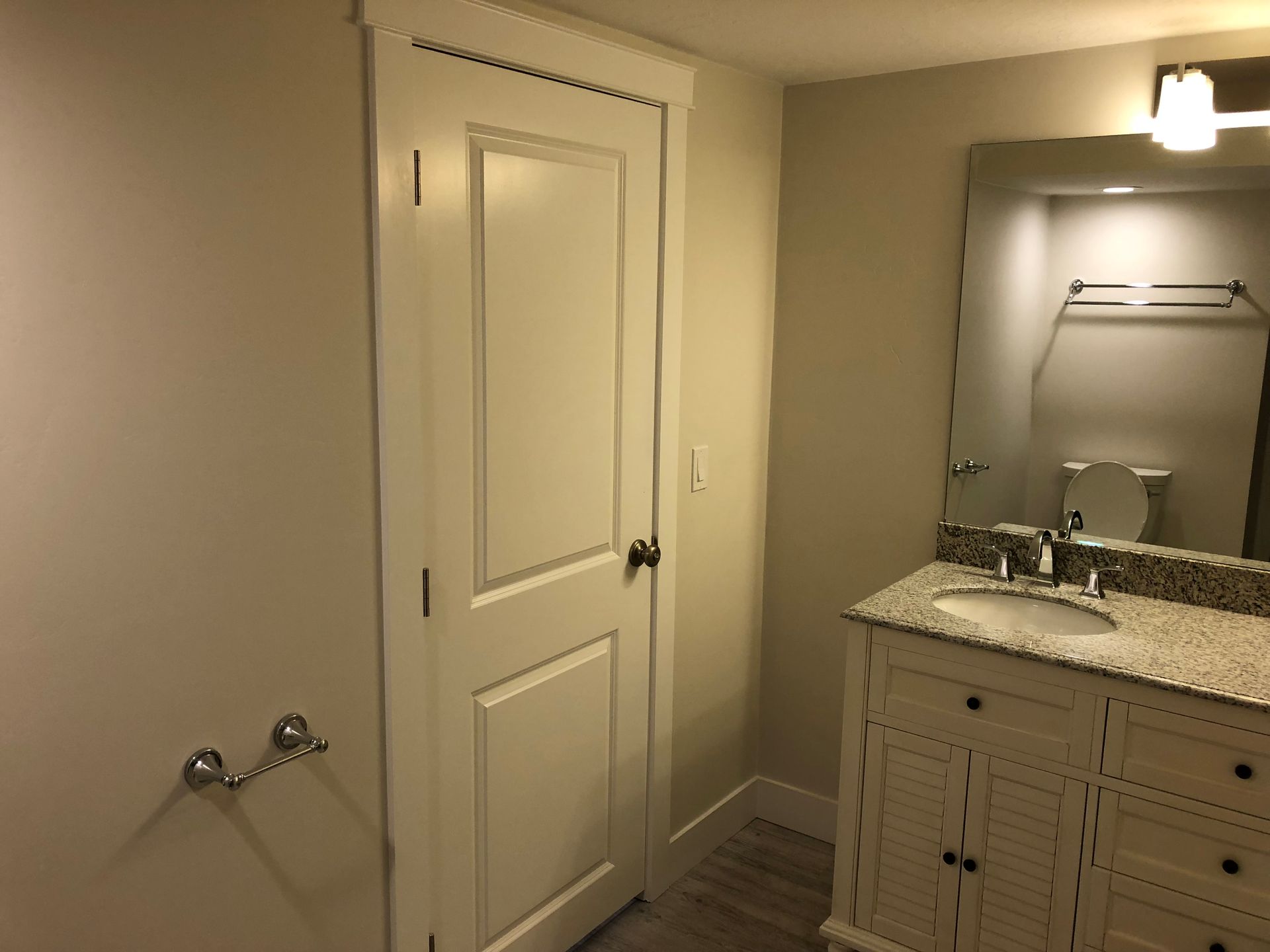 A bathroom with a sink , toilet and mirror