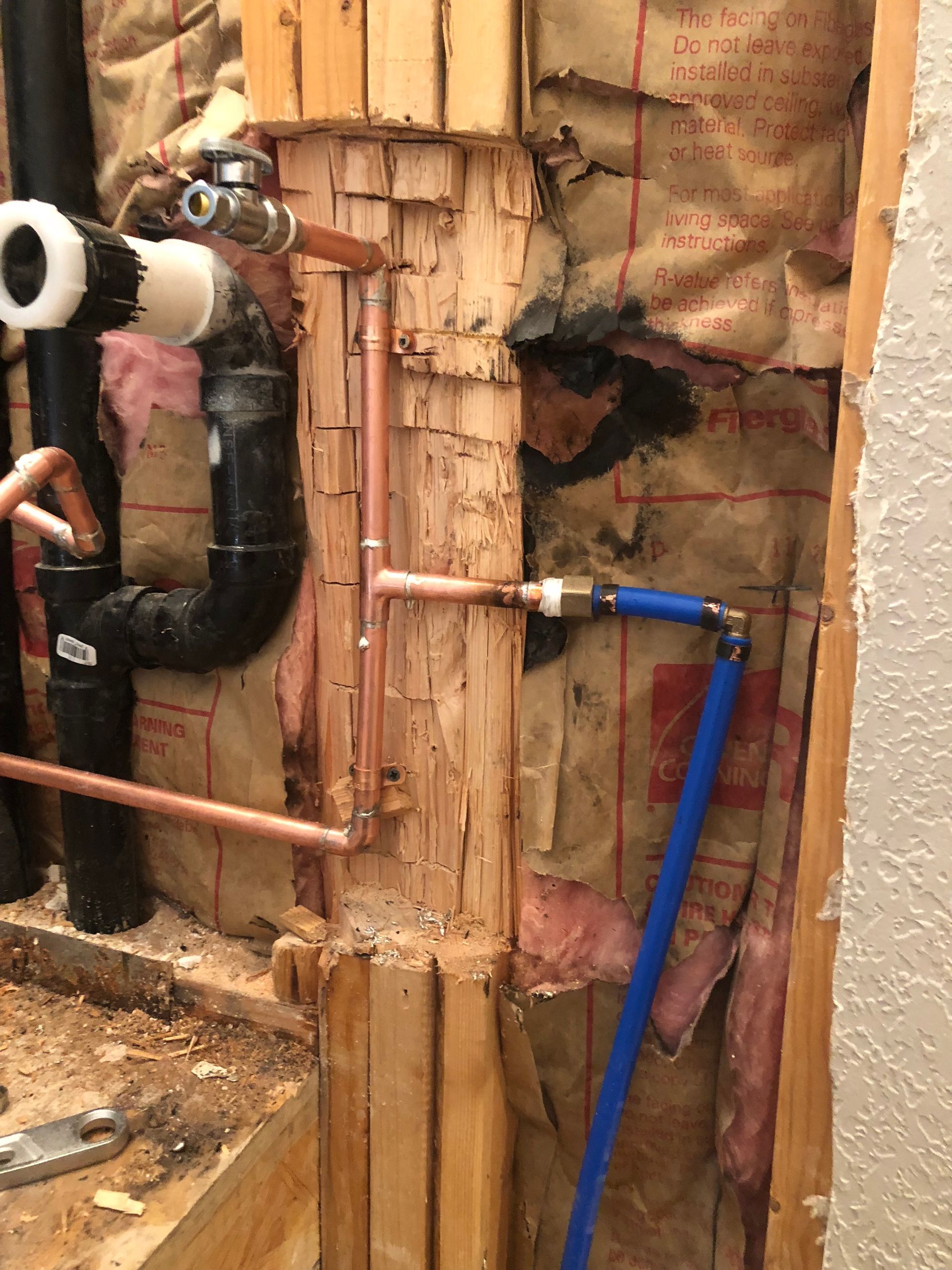 A wall with a lot of pipes coming out of it