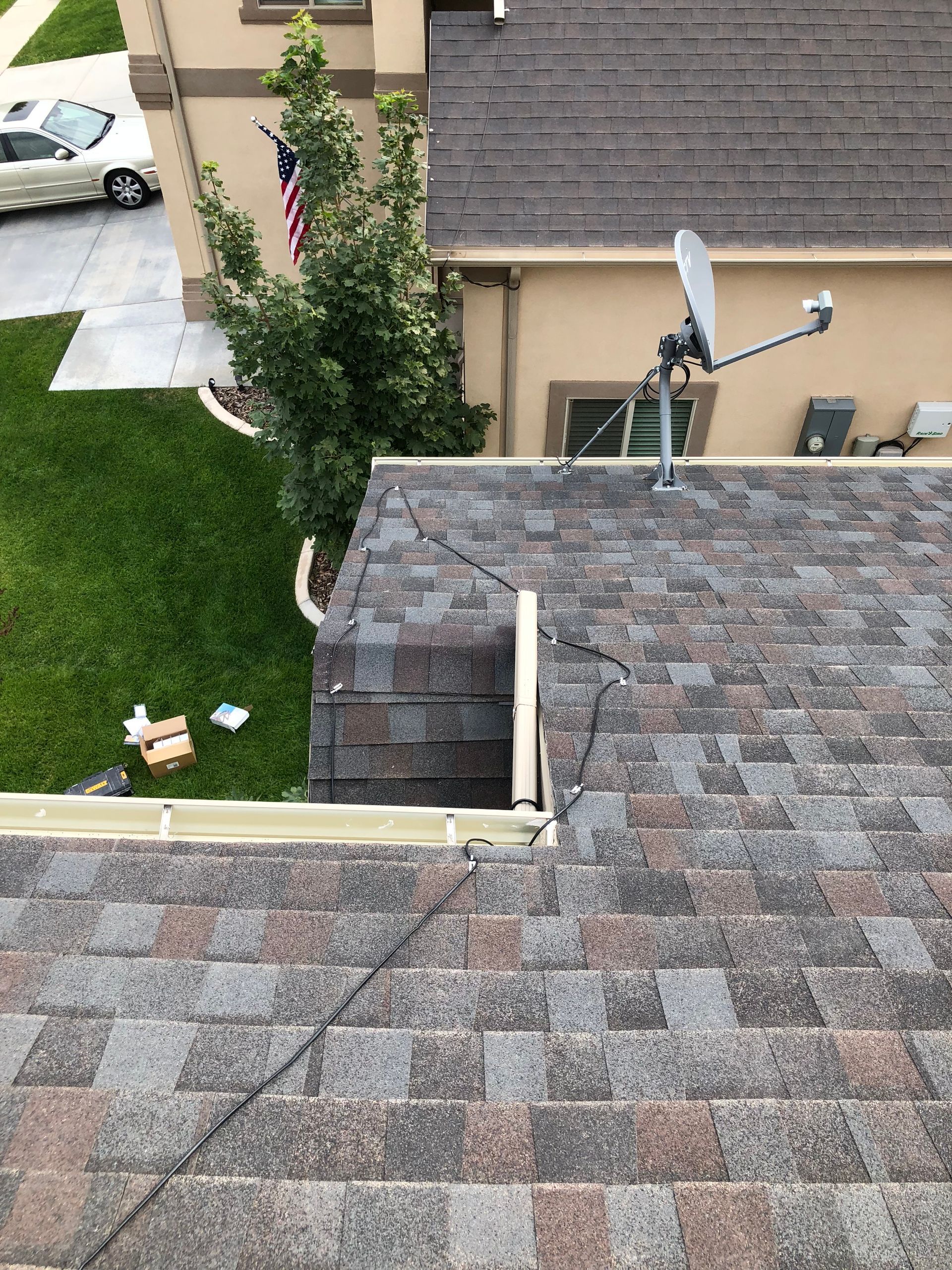 There is a satellite dish on the roof of a house.