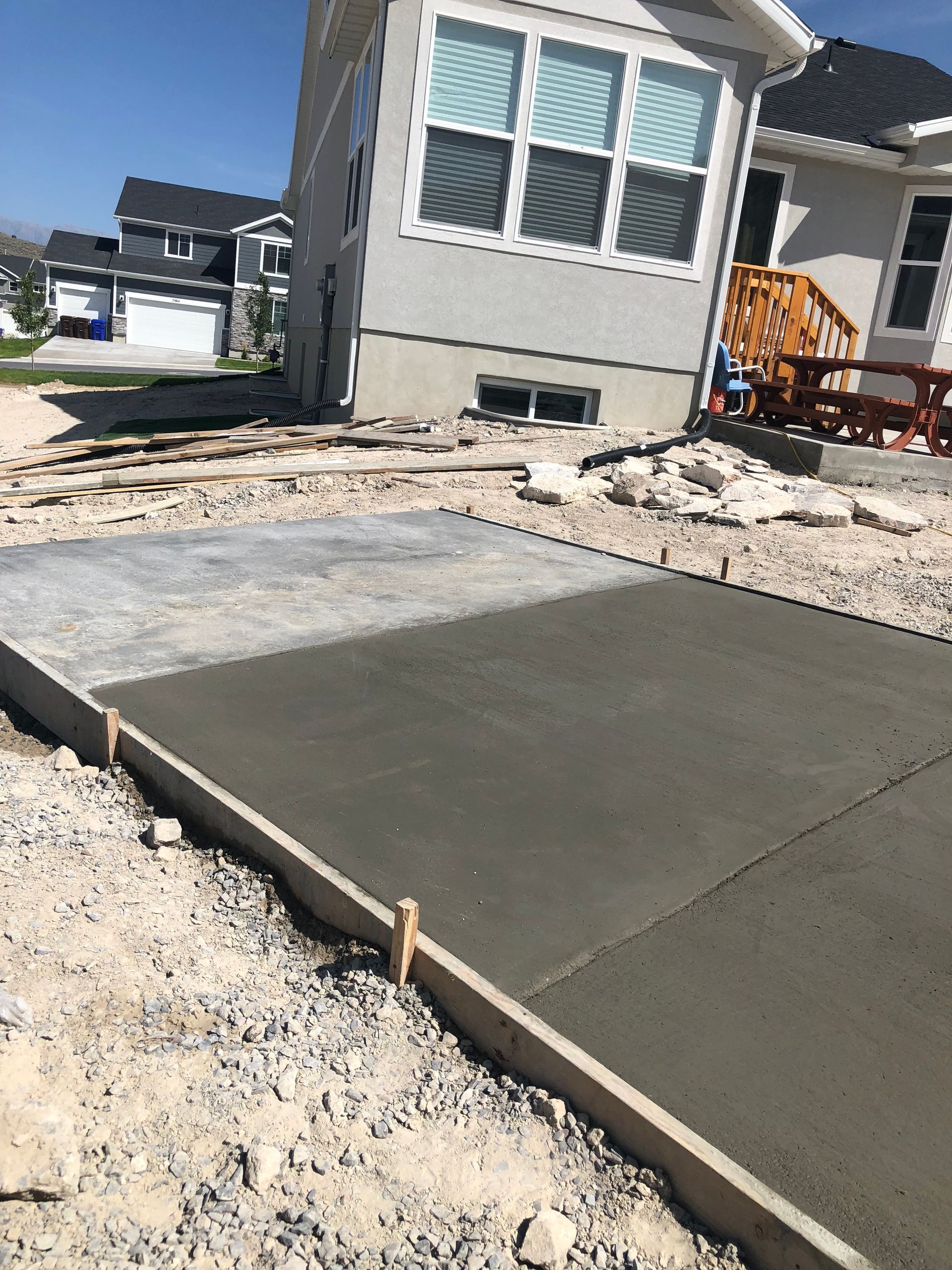 A concrete driveway is being built in front of a house.