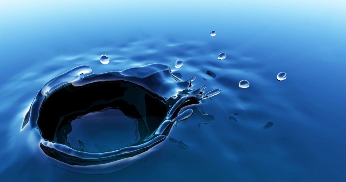 A dark water whirlpool with small splashes on a blue surface
