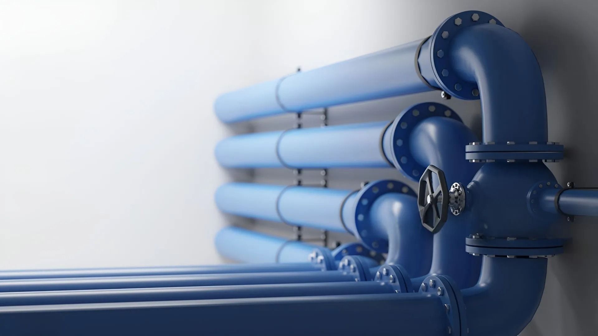 Blue industrial pipes with valves, extending from right to left on a white background