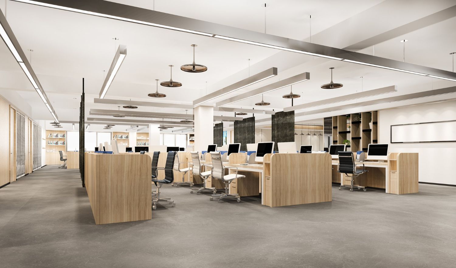 An empty office with wooden desks and chairs and computers.