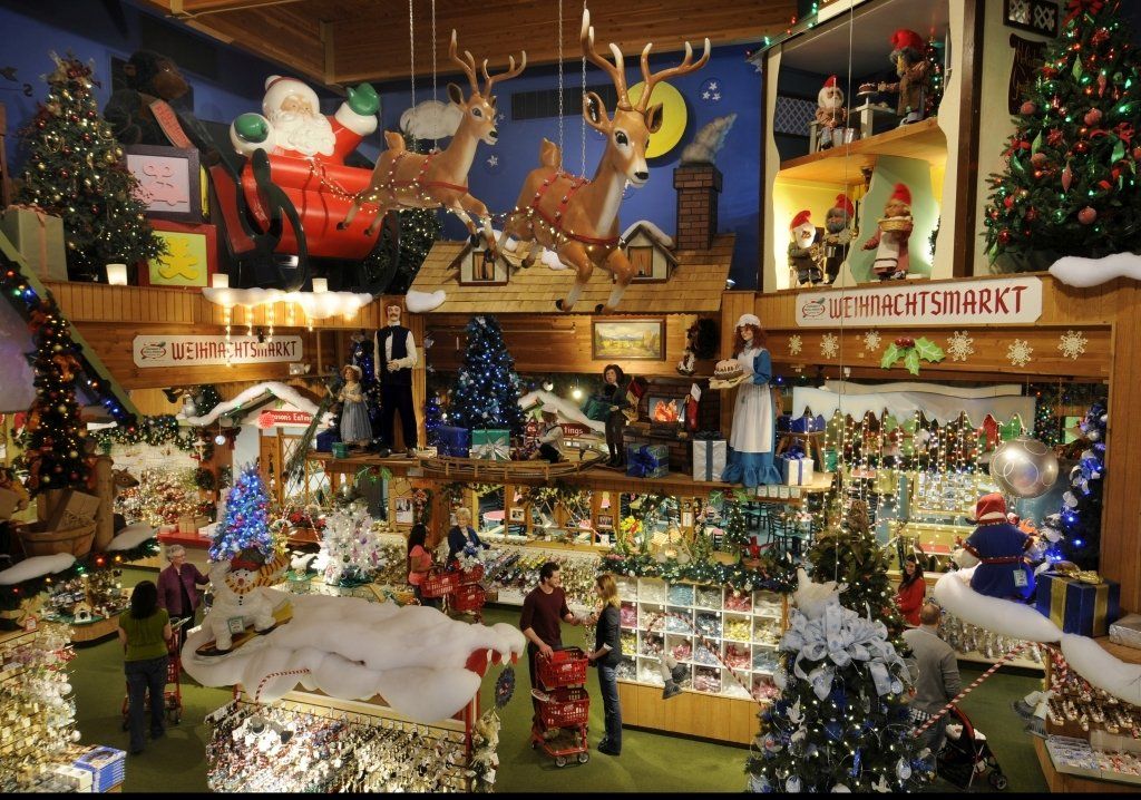 Christmas shop interior with festive decorations and shoppers.