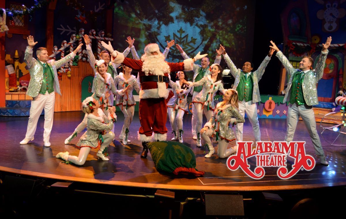 A theater stage with Santa and elves in a Christmas performance. Alabama Theatre logo.