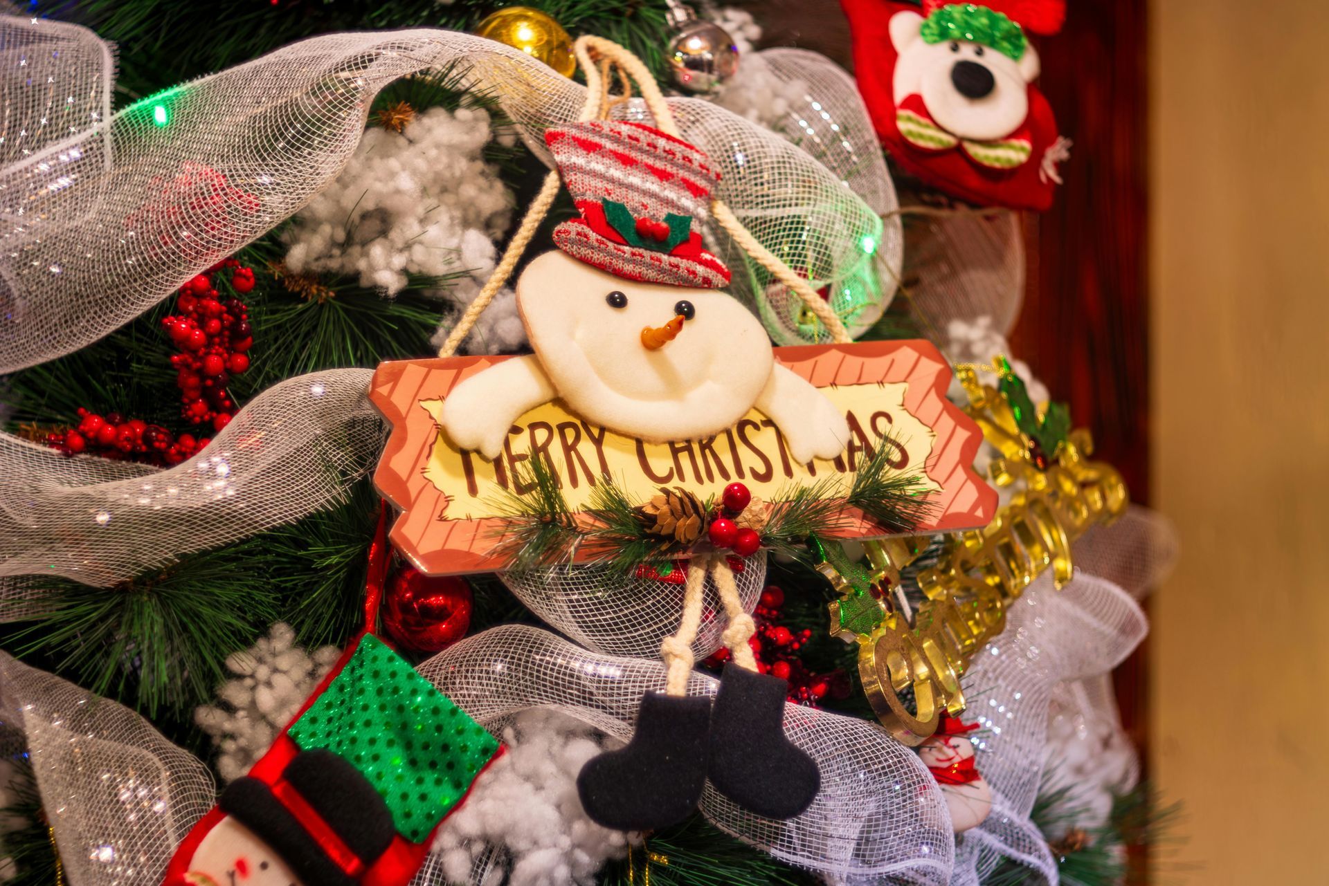 Snowman ornament on a Christmas tree with 