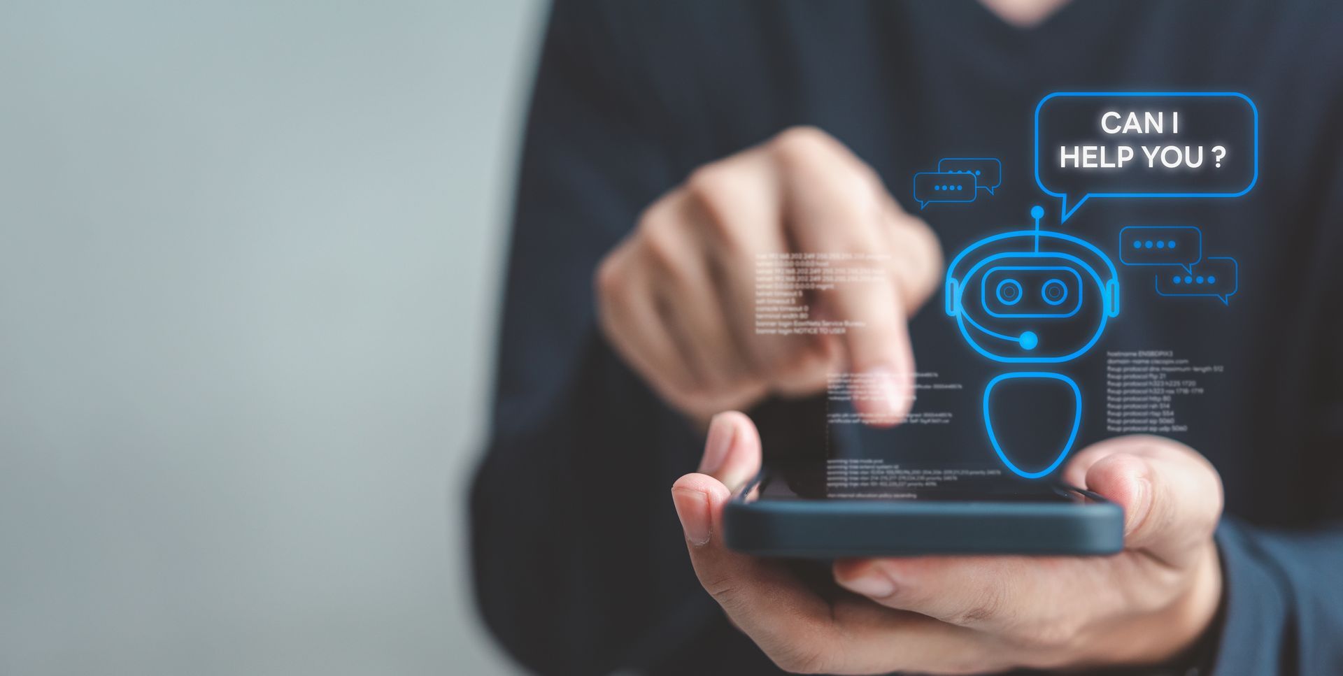 Hands using a smartphone with a glowing blue chatbot icon and “Can I help you?” on screen