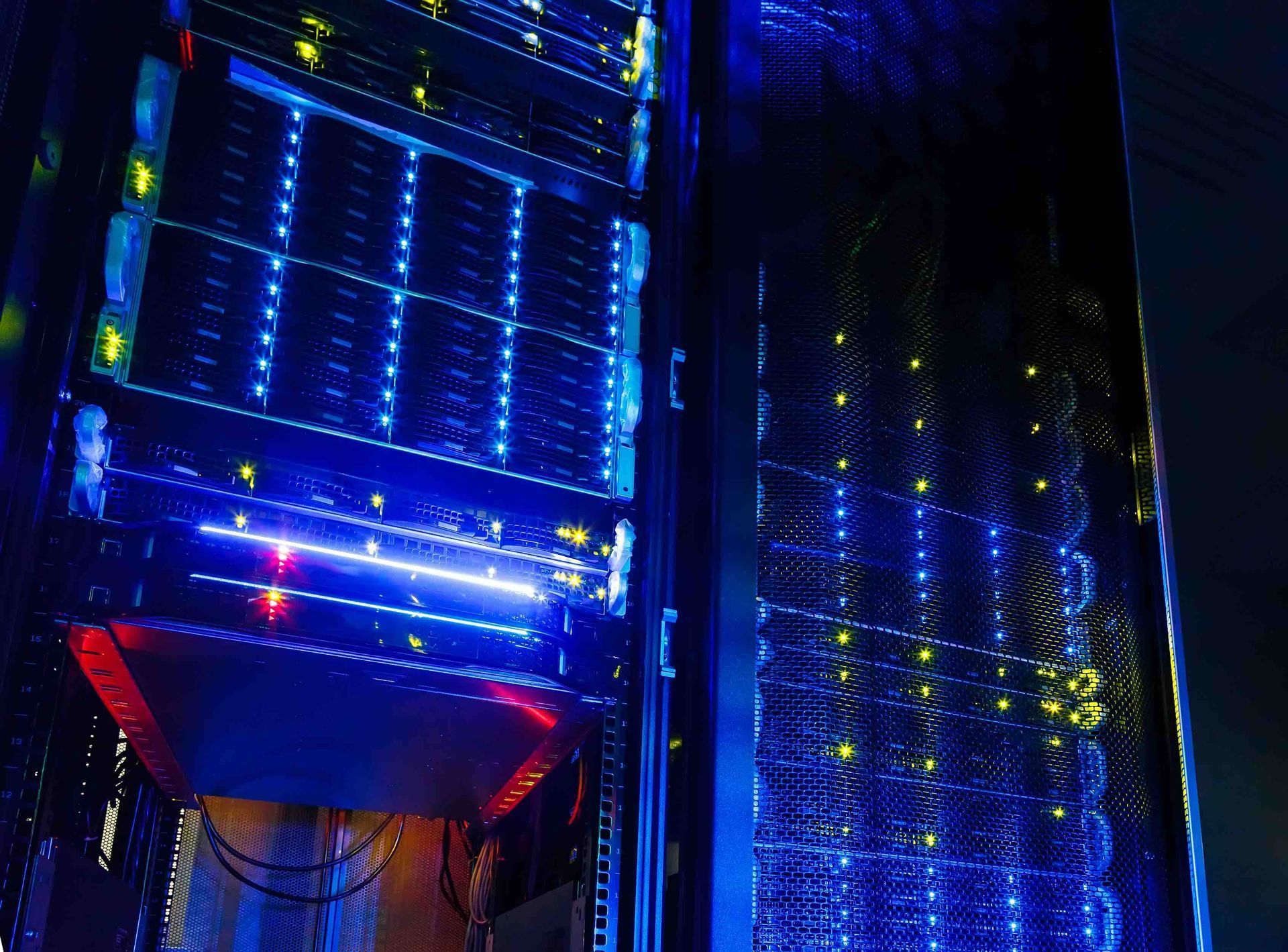 Blue-lit server racks glowing in a dark data center