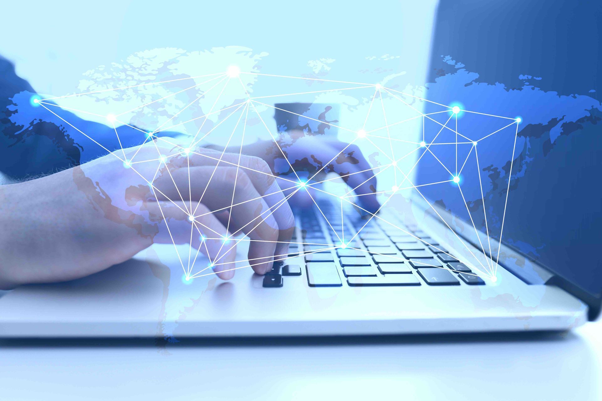 Hands typing on a laptop with a digital network overlay in a blue tech setting