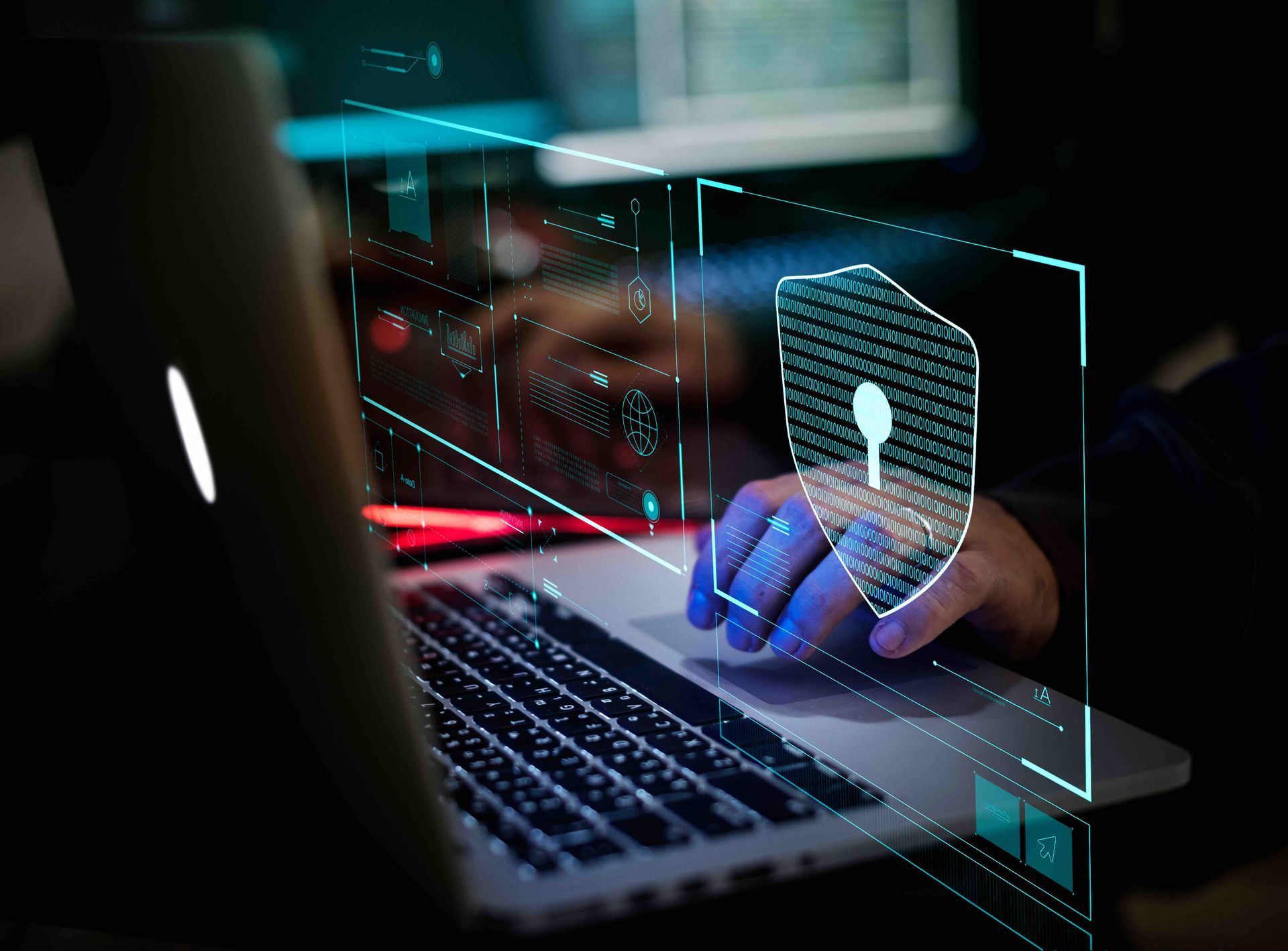 Person typing on a laptop with a glowing security lock hologram overlay