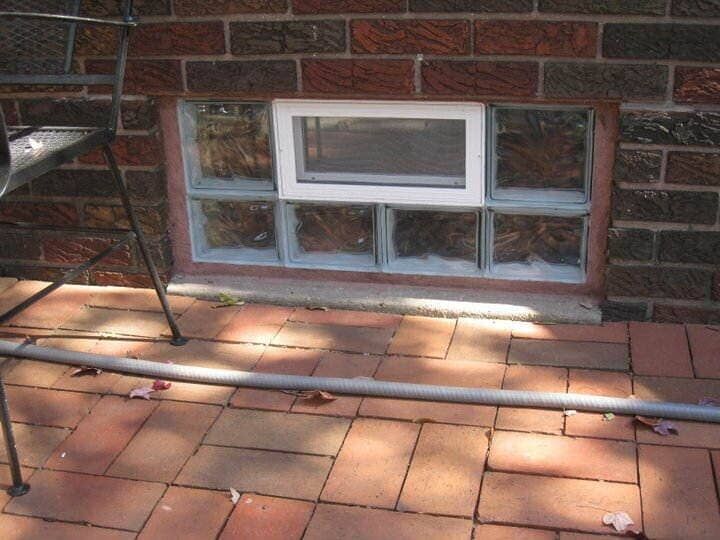A brick wall with a window in it