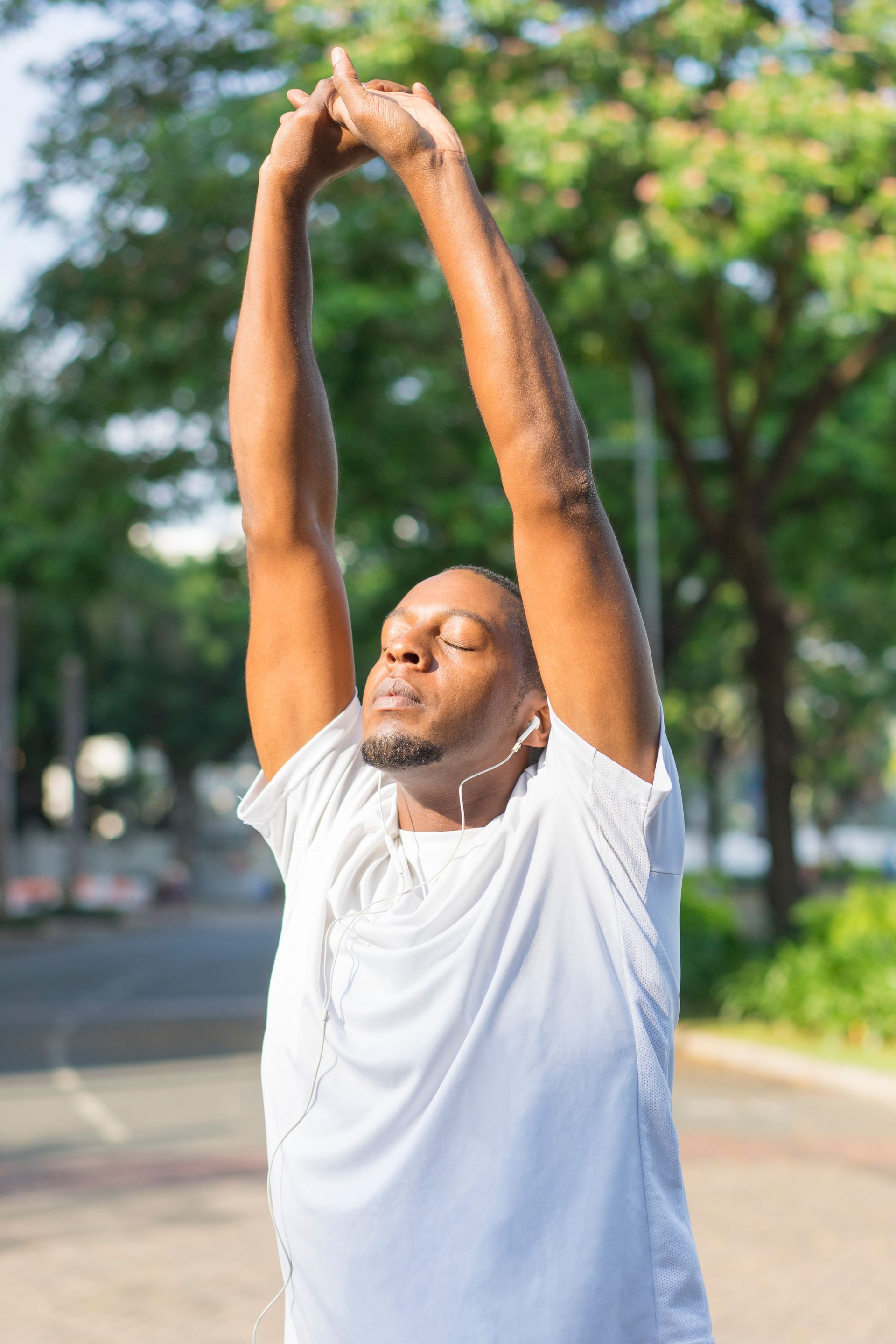 a man stretches his arms while listening to music