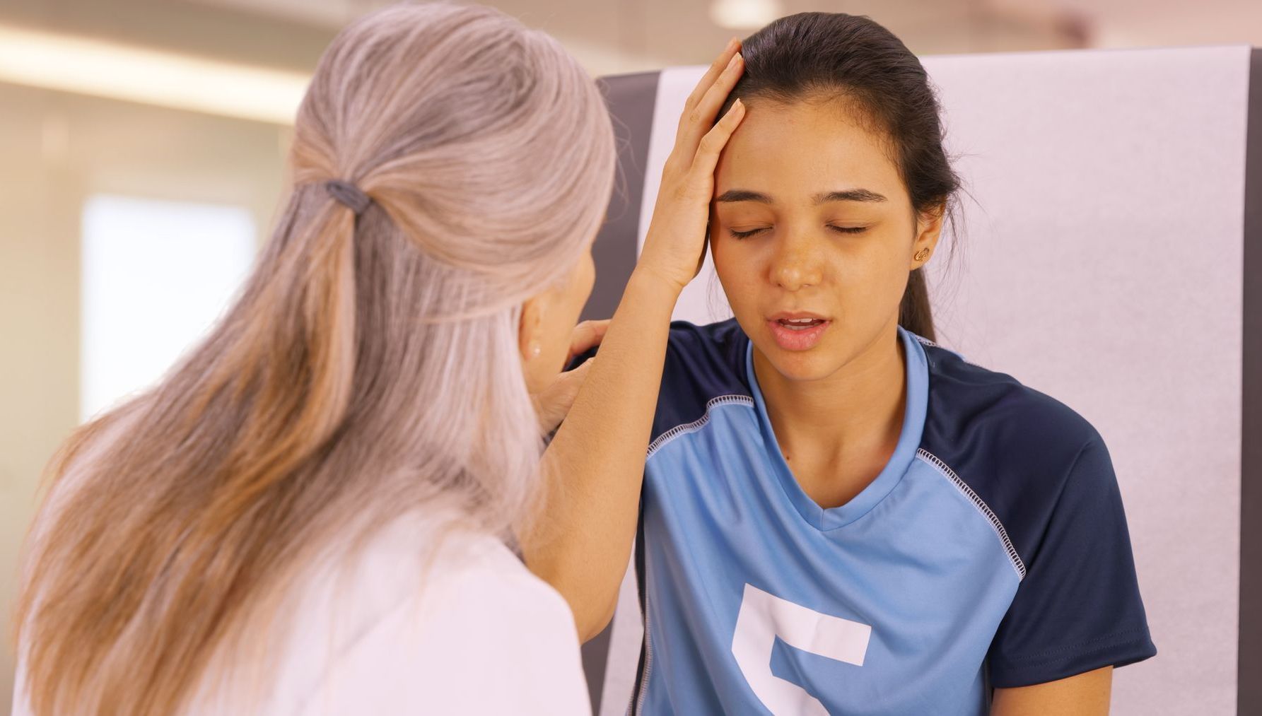 a woman in a blue shirt with the letter l on it