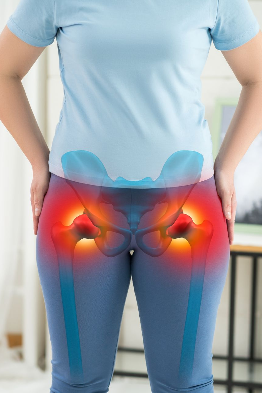 Person in blue shirt and jeans with hip and lower-back pain highlighted in red and orange.
