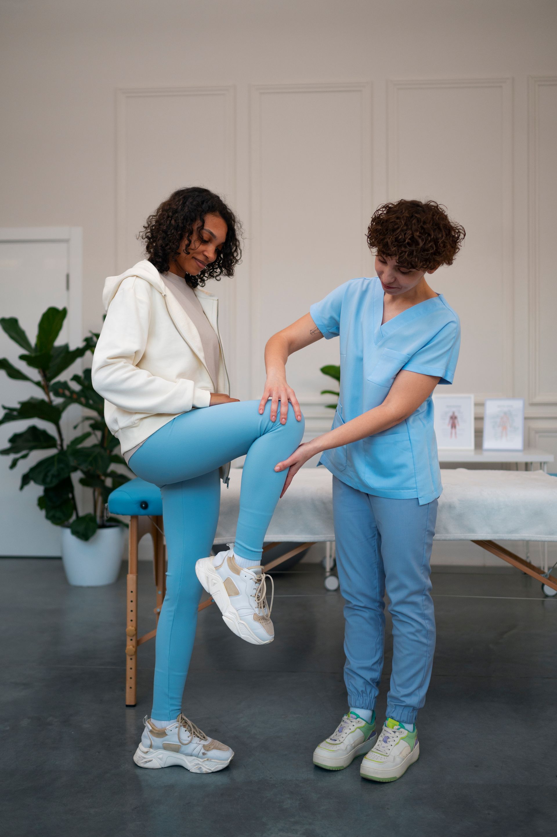 a woman is getting her leg examined by a nurse