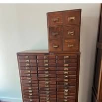 Wooden apothecary cabinet with many drawers.