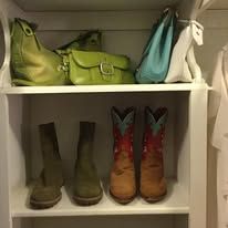 Shelf with purses and boots. Green, teal purses, and brown cowboy boots.