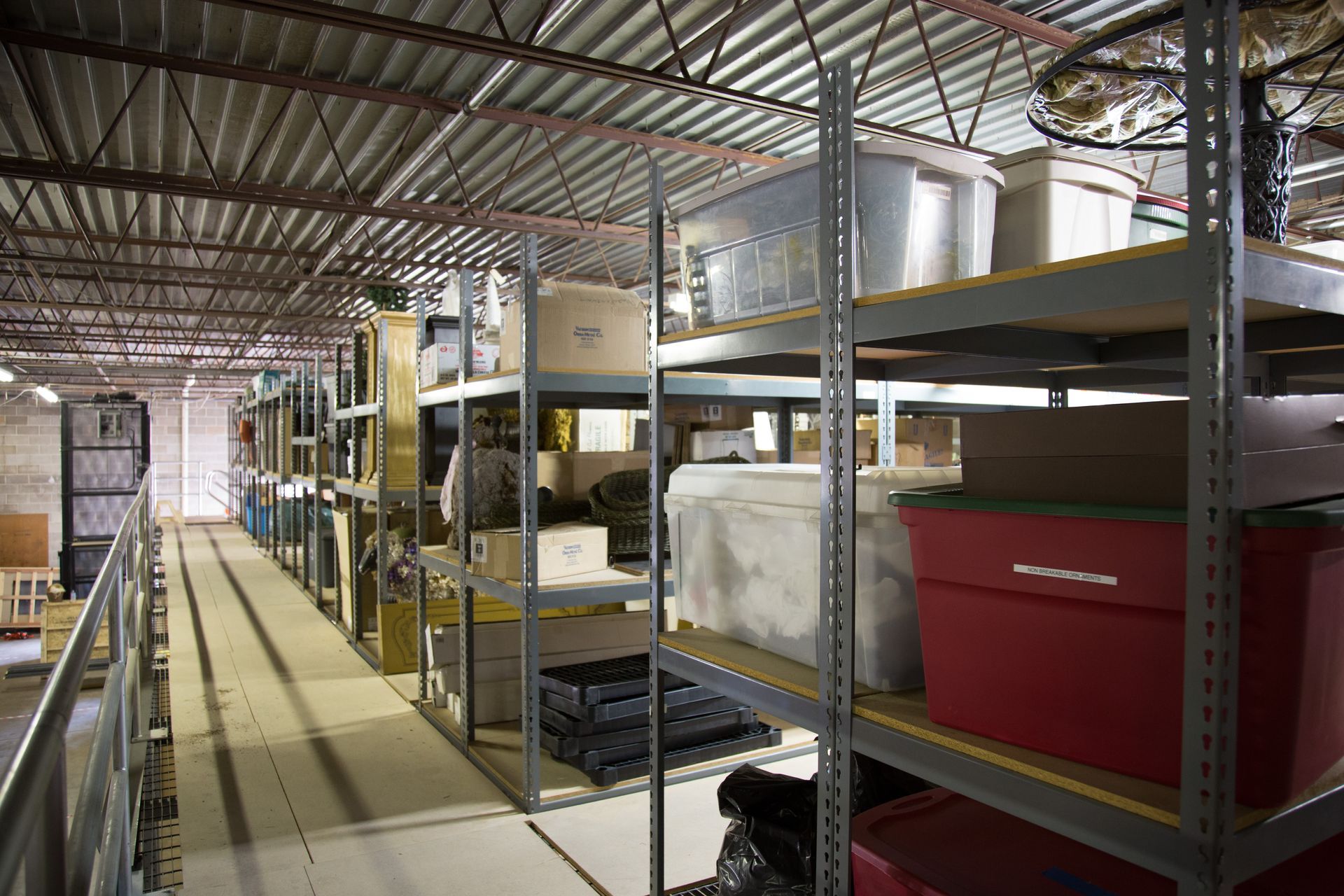 Storage room with metal shelves filled with boxes and containers.