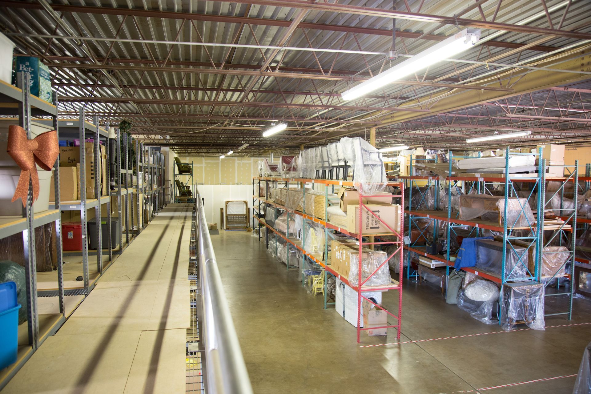 Warehouse interior with shelves of boxes and items.