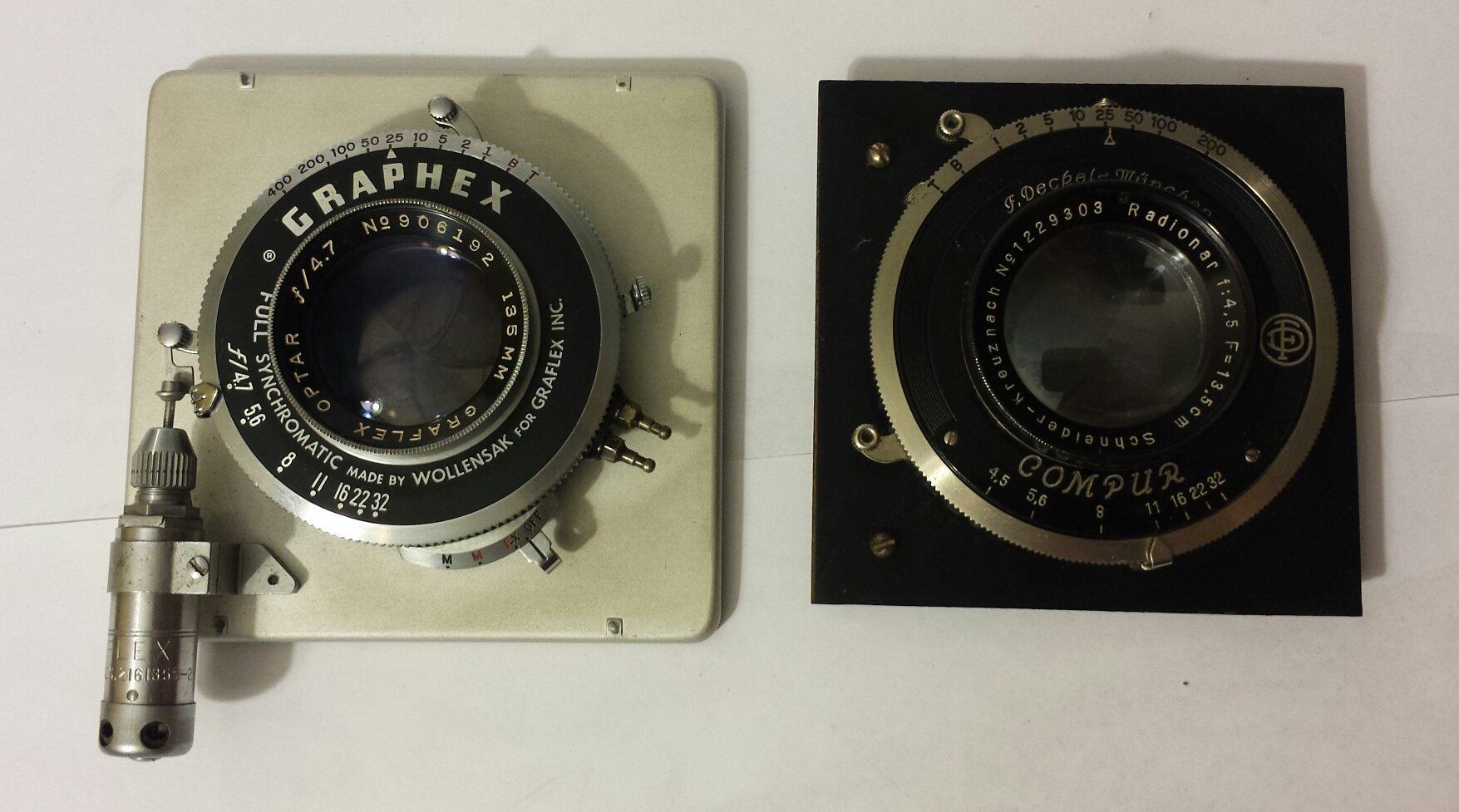 Two camera lenses one of which says graphex on it