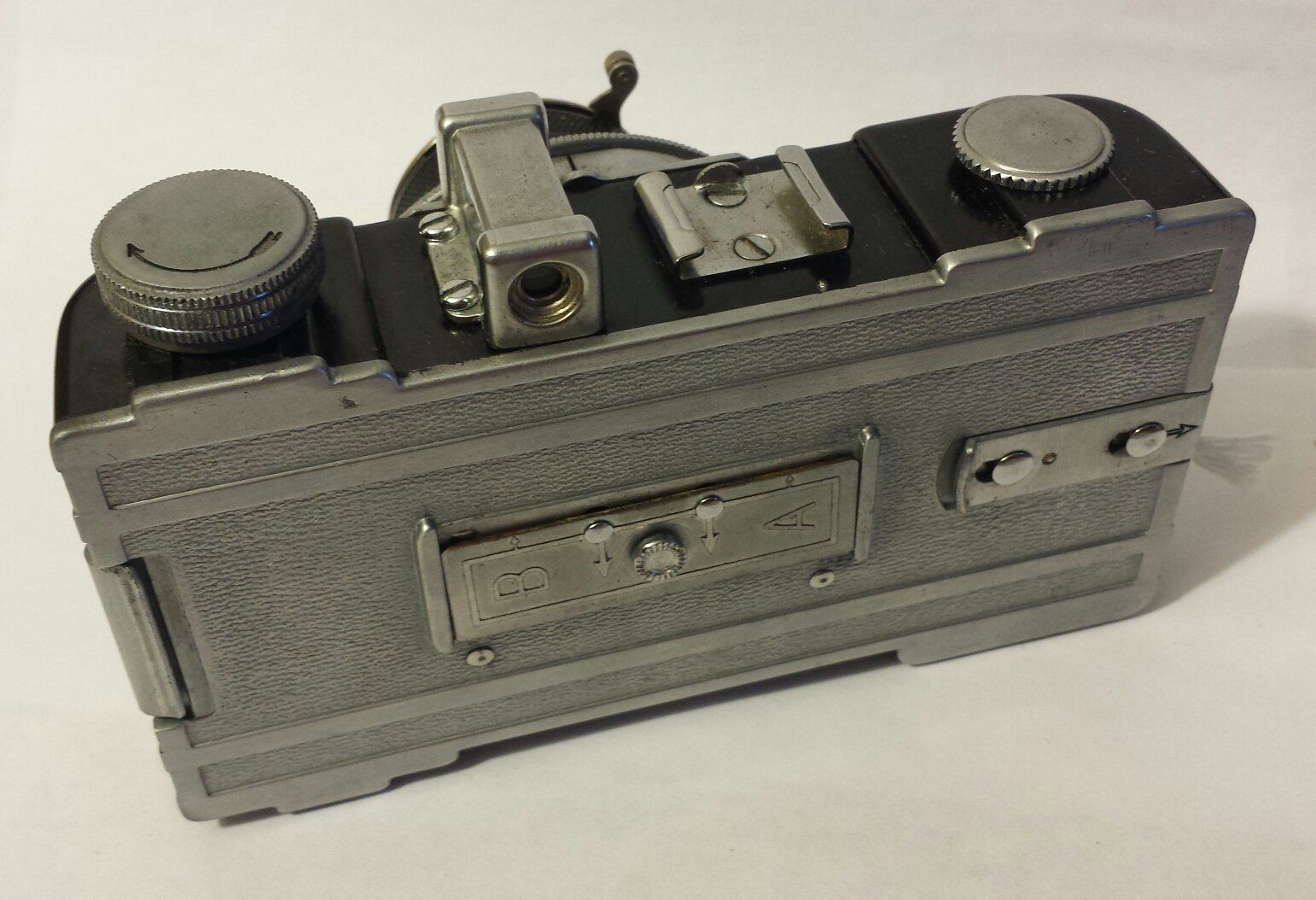 A silver and black camera with the word fuji on the back