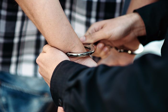 A driver suspected of driving while intoxicated getting arrested.