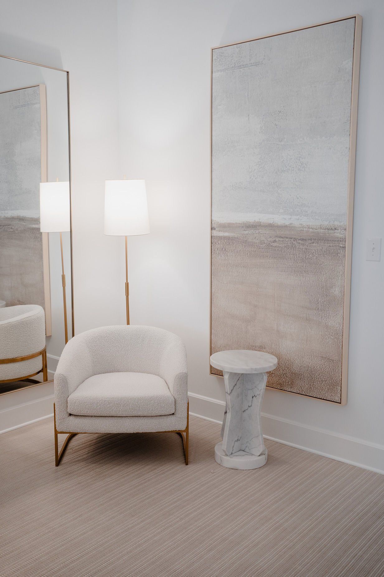 A room with a chair and two paintings on the wall