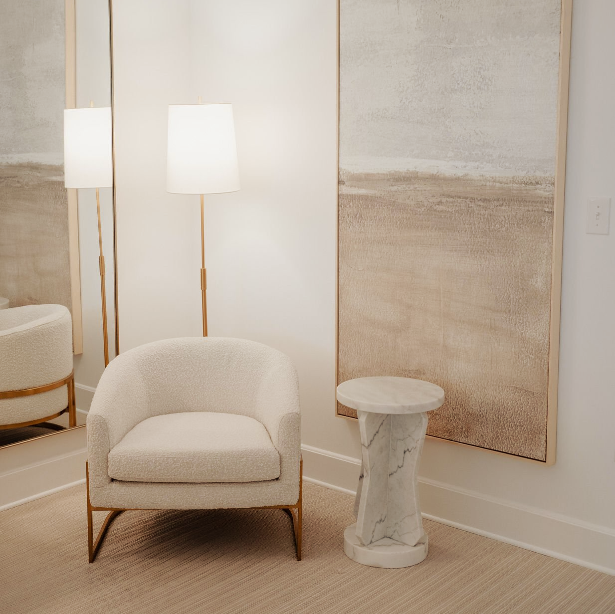 A room with a chair a table and a lamp