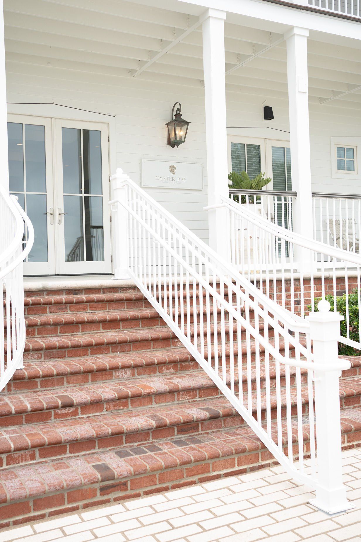 Stairs leading up to a white house with a white railing
