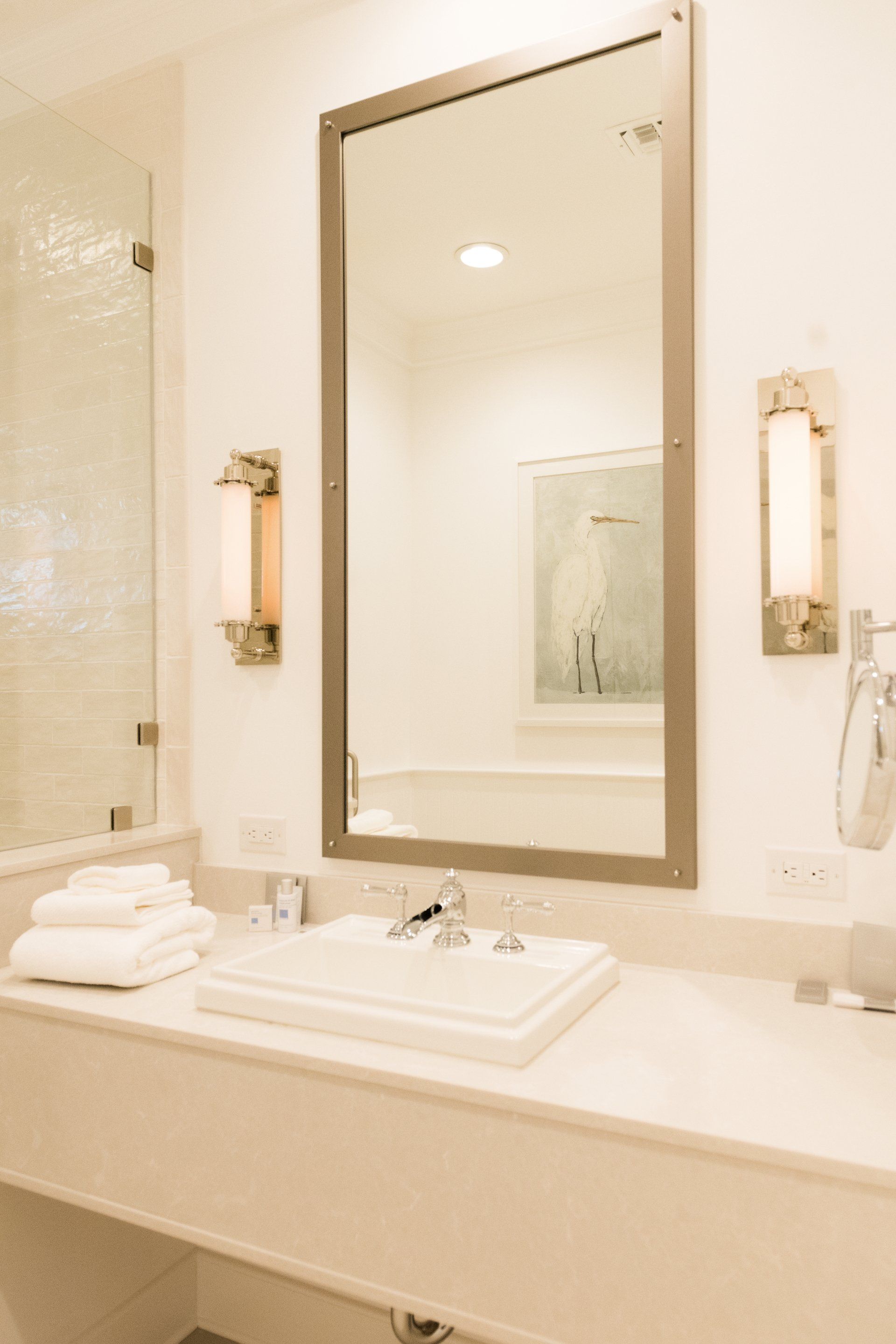 A bathroom with a sink and a large mirror