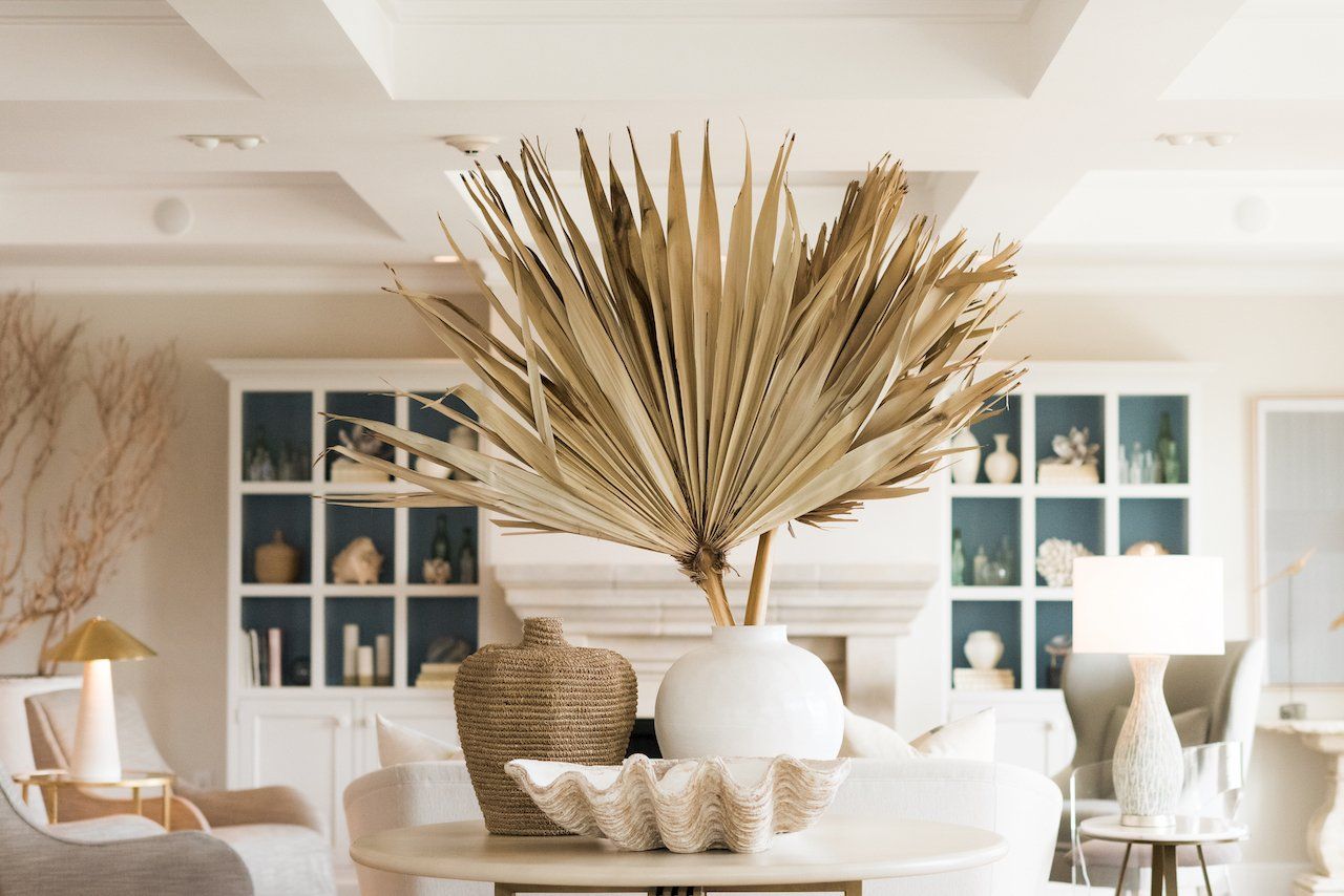 A boutique hotel entrance in downtown pensacola with a palm tree in a vase on a table